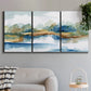 Three-panel canvas wall art featuring abstract blue watercolor landscape, displayed in a modern living room above a sofa.