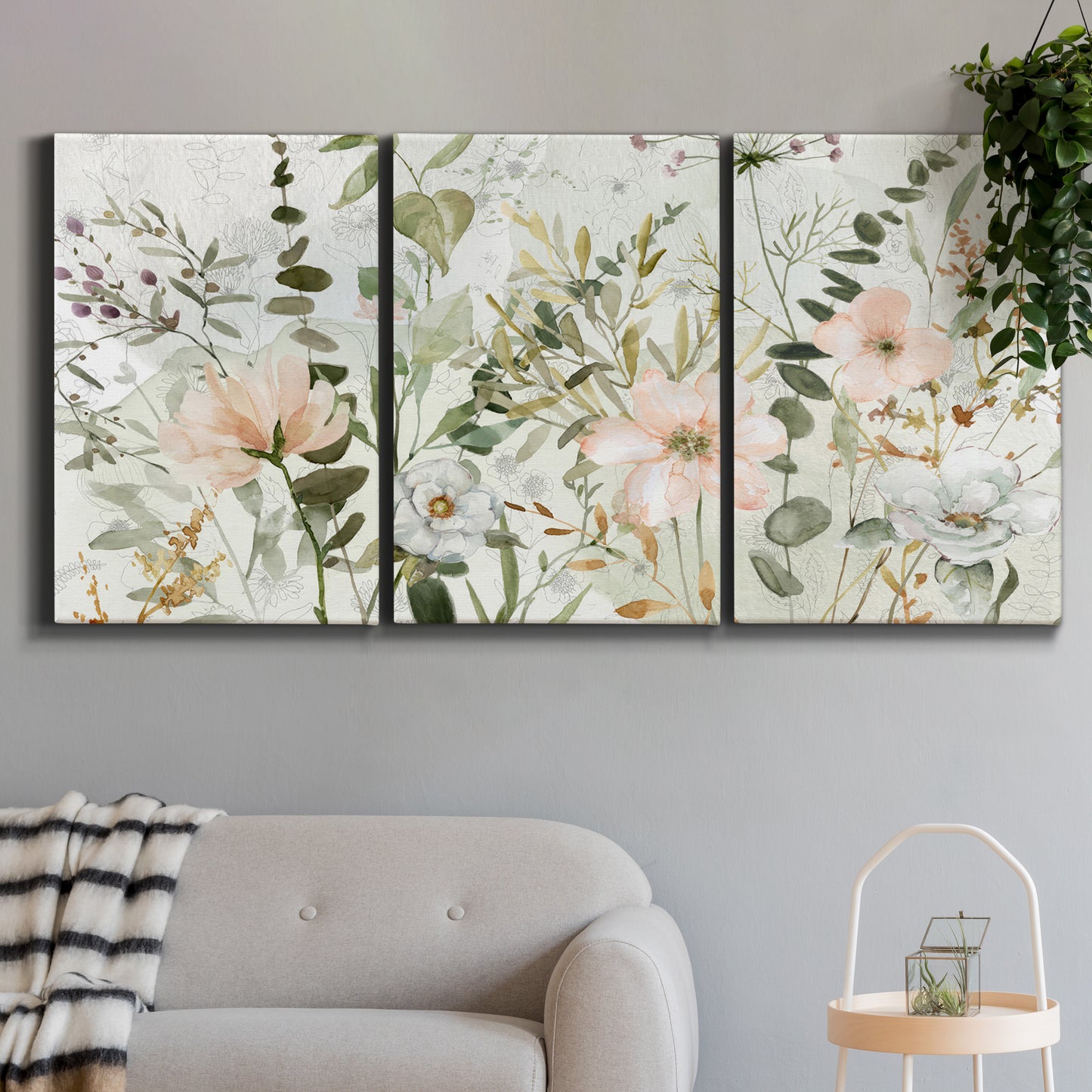 Three-panel canvas wall art featuring vintage floral botanical sketchbook, displayed in a modern living room above a sofa.