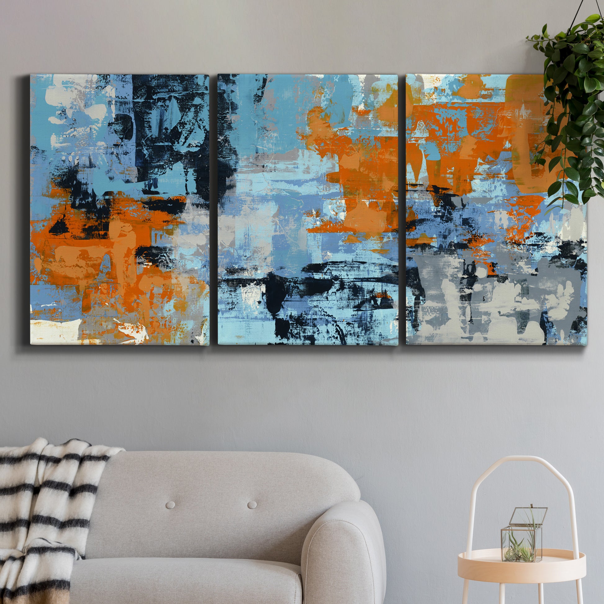 Three-panel canvas wall art featuring mid century abstract playground shapes, displayed in a modern living room above a sofa.