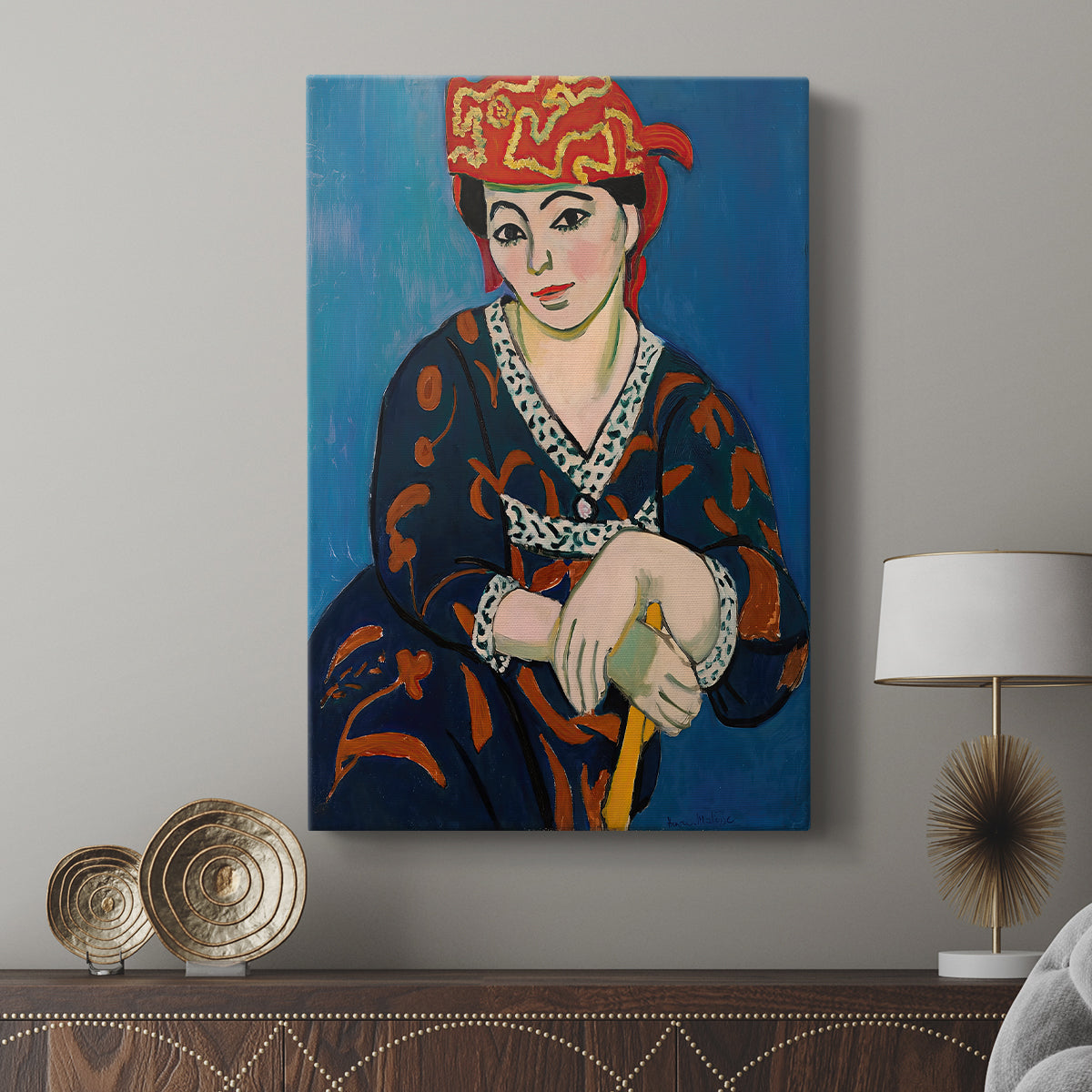 Canvas art print featuring a vibrant portrait with decorative headwear and strong color displayed in a modern interior space.