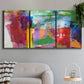 Three-panel canvas wall art featuring vibrant abstract color field panels, displayed in a modern living room above a sofa.