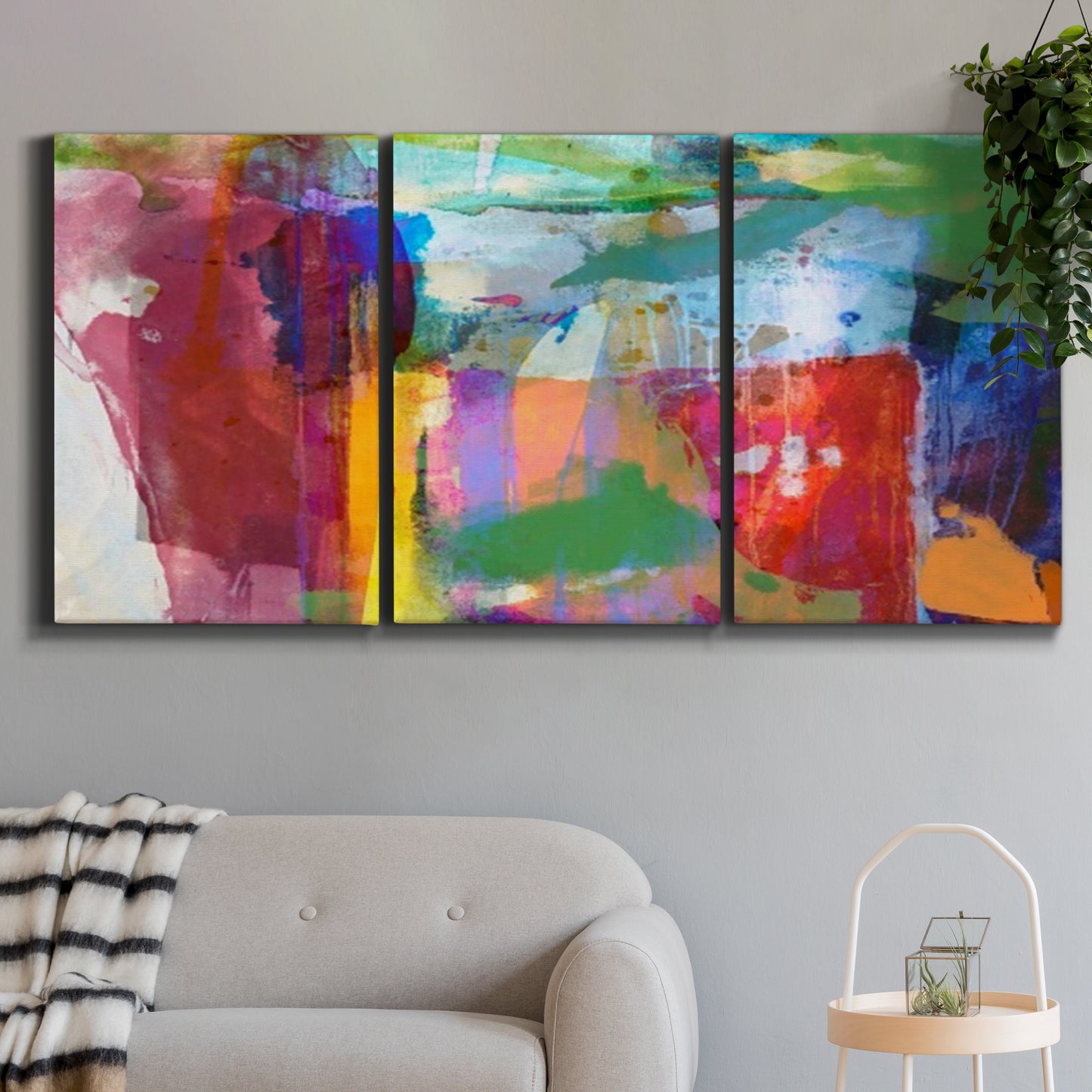 Three-panel canvas wall art featuring vibrant abstract color field panels, displayed in a modern living room above a sofa.