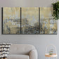 Three-panel canvas wall art featuring gold toned abstract horizon, displayed in a modern living room above a sofa.