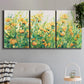 Three-panel canvas wall art featuring colorful garden flowers in bloom, displayed in a modern living room above a sofa.
