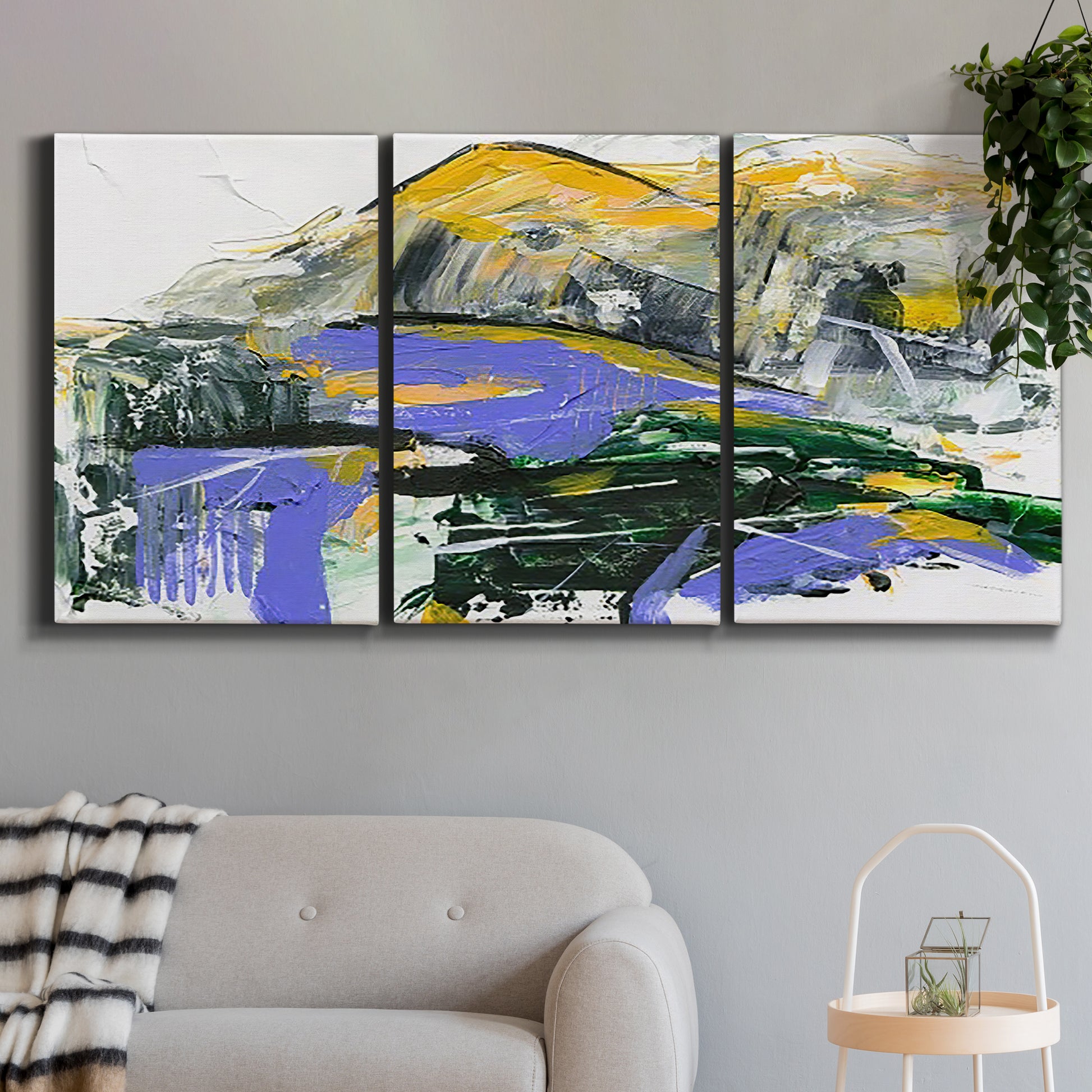 Three-panel canvas wall art featuring quiet abstract mountain silhouette, displayed in a modern living room above a sofa.