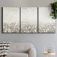 Three-panel canvas wall art featuring dark textured abstract mist, displayed in a modern living room above a sofa.