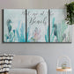 Three-panel canvas wall art featuring coastal typography with seahorses, displayed in a modern living room above a sofa.