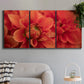 Three-panel canvas wall art featuring vivid red floral close up, displayed in a modern living room above a sofa.