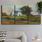 Three-panel canvas wall art featuring rural barn landscape with fields, displayed in a modern living room above a sofa.