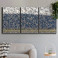 Three-panel canvas wall art featuring group of animals in open field, displayed in a modern living room above a sofa.