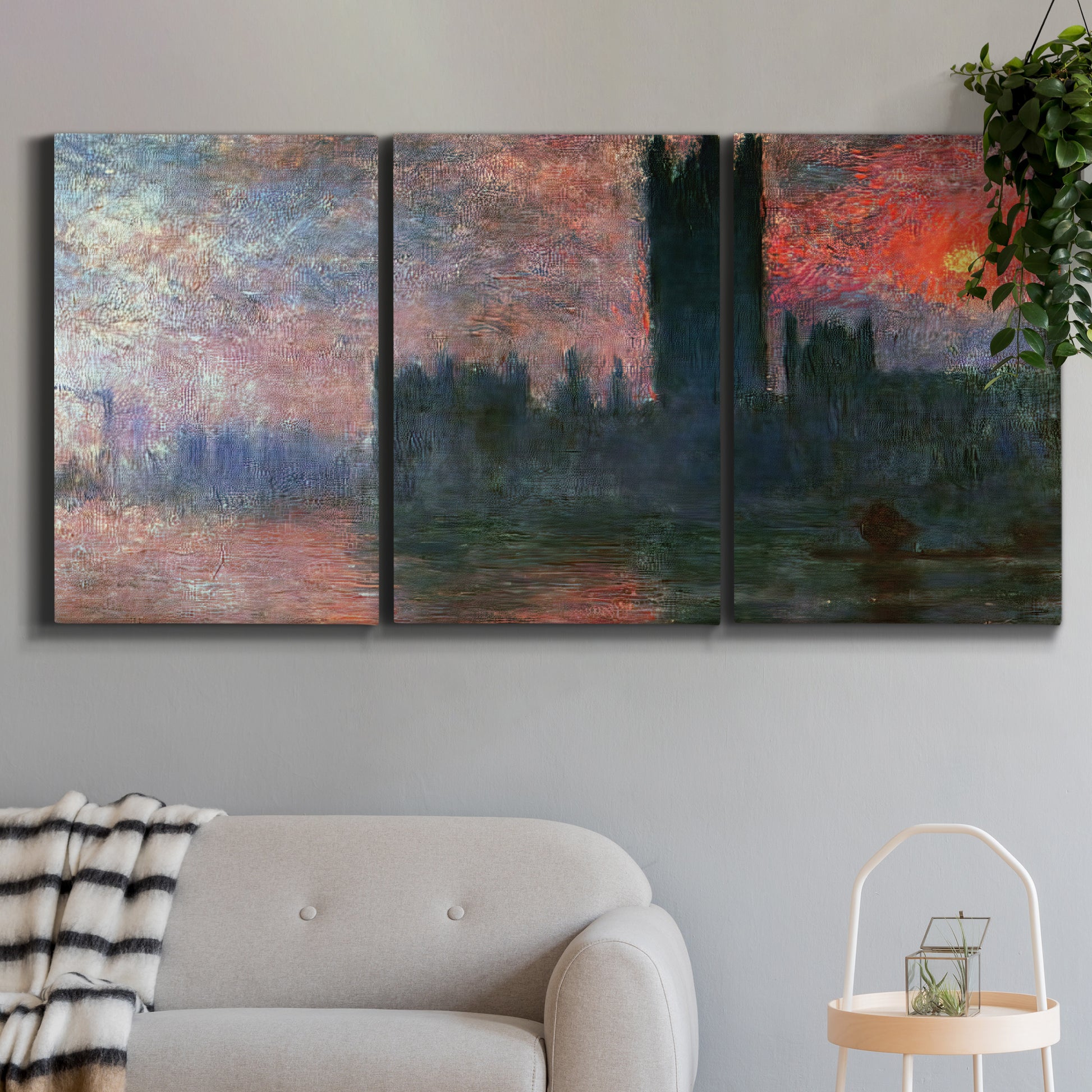 Three-panel canvas wall art featuring parliament silhouetted at dusk, displayed in a modern living room above a sofa.