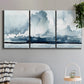 Three-panel canvas wall art featuring abstract rainstorm watercolor, displayed in a modern living room above a sofa.