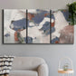 Three-panel canvas wall art featuring cool blue abstract layered composition, displayed in a modern living room above a sofa.