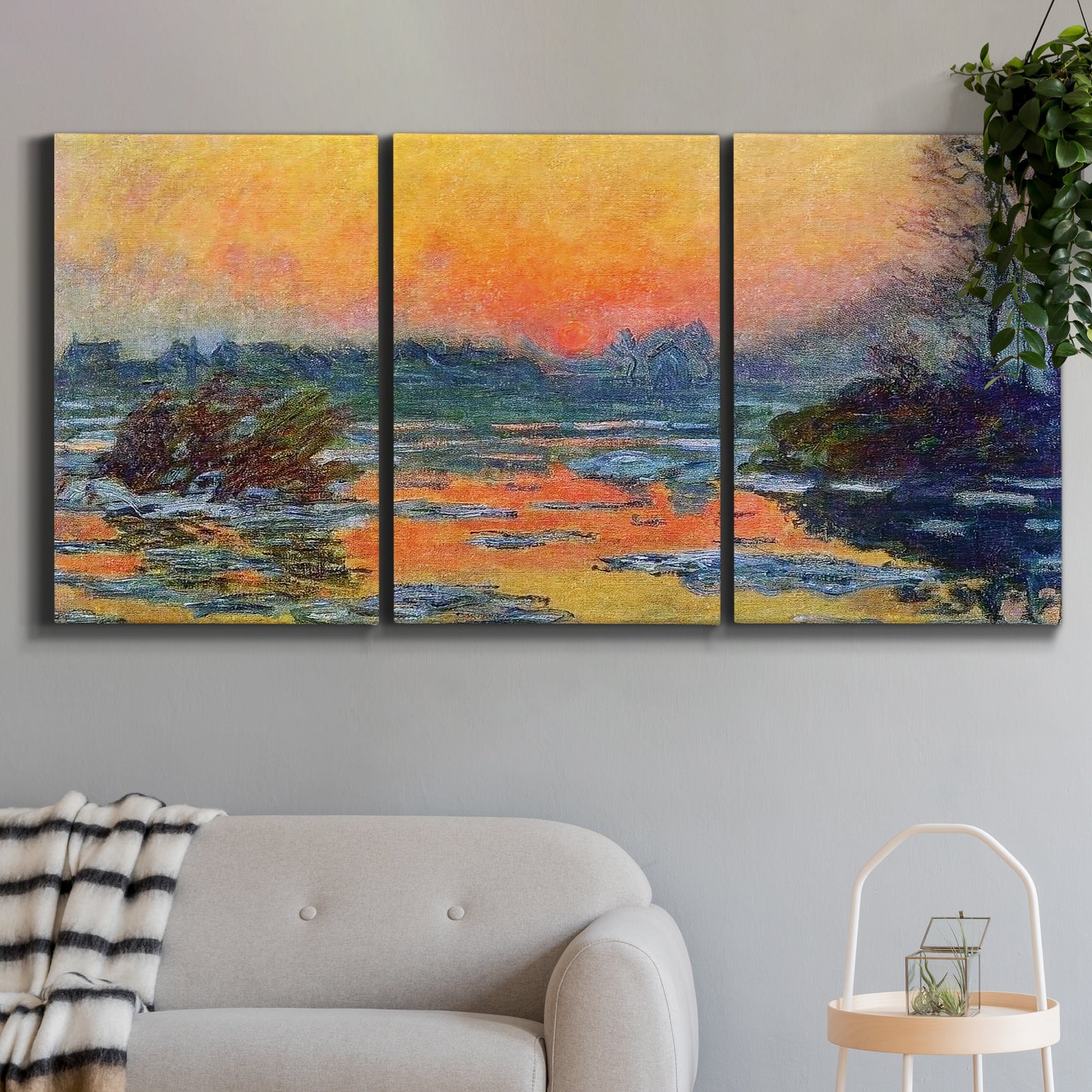 Three-panel canvas wall art featuring winter sunset over river, displayed in a modern living room above a sofa.