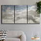 Three-panel canvas wall art featuring aerial landscape view photograph, displayed in a modern living room above a sofa.
