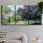 Three-panel canvas wall art featuring formal city park with trees, displayed in a modern living room above a sofa.