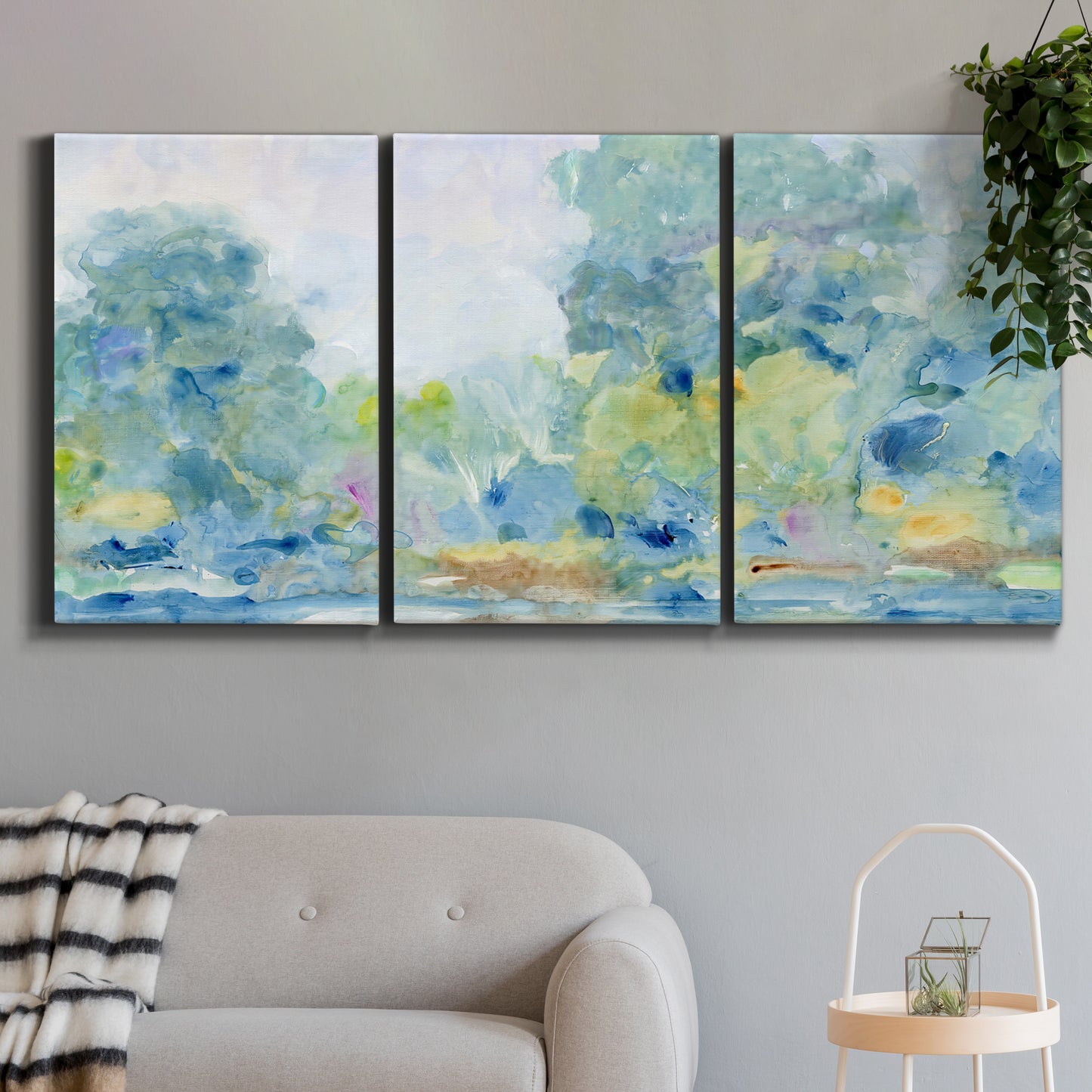 Three-panel canvas wall art featuring quiet abstract morning landscape, displayed in a modern living room above a sofa.