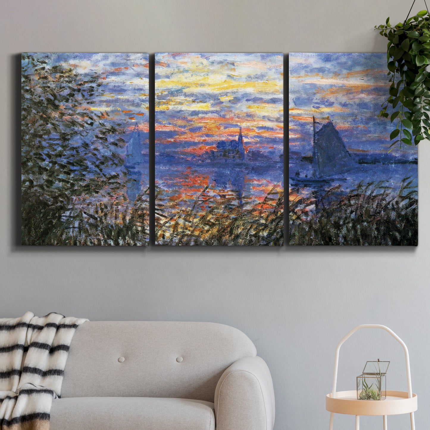 Three-panel canvas wall art featuring river sunset with reflections, displayed in a modern living room above a sofa.