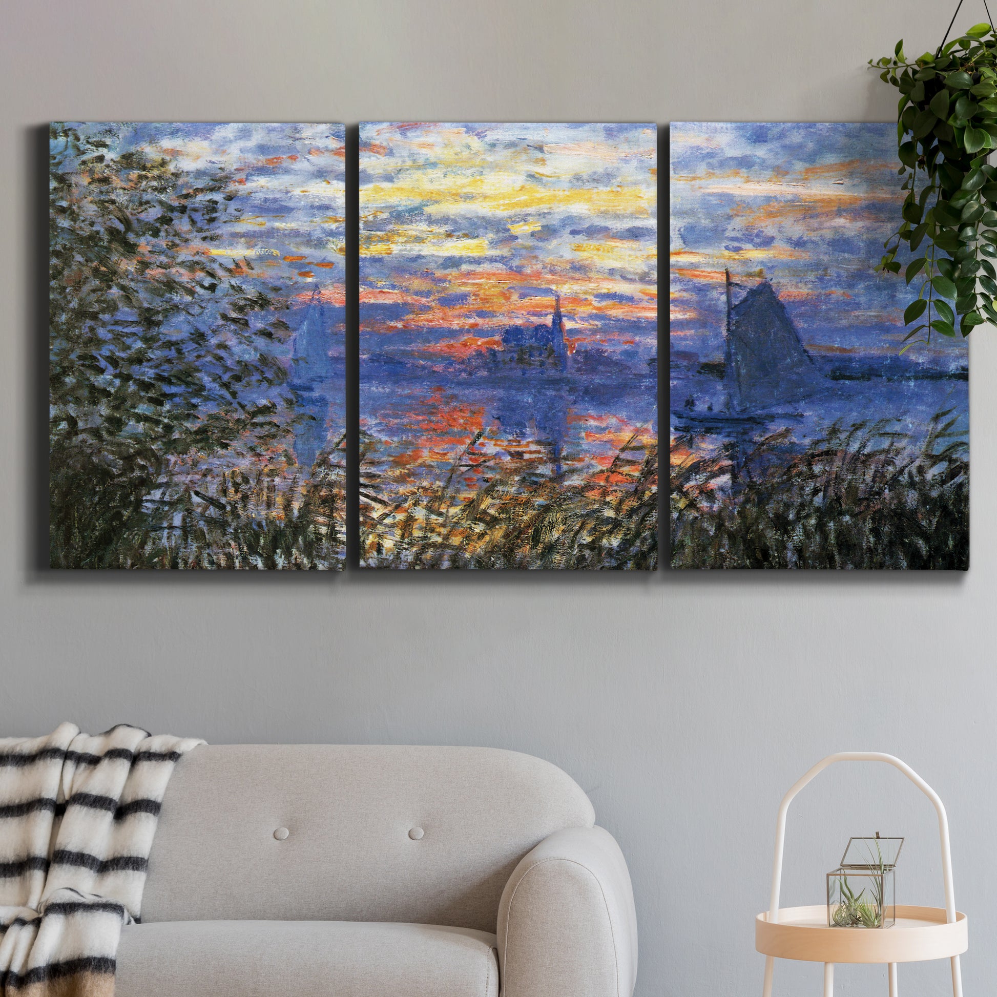 Three-panel canvas wall art featuring river sunset with reflections, displayed in a modern living room above a sofa.