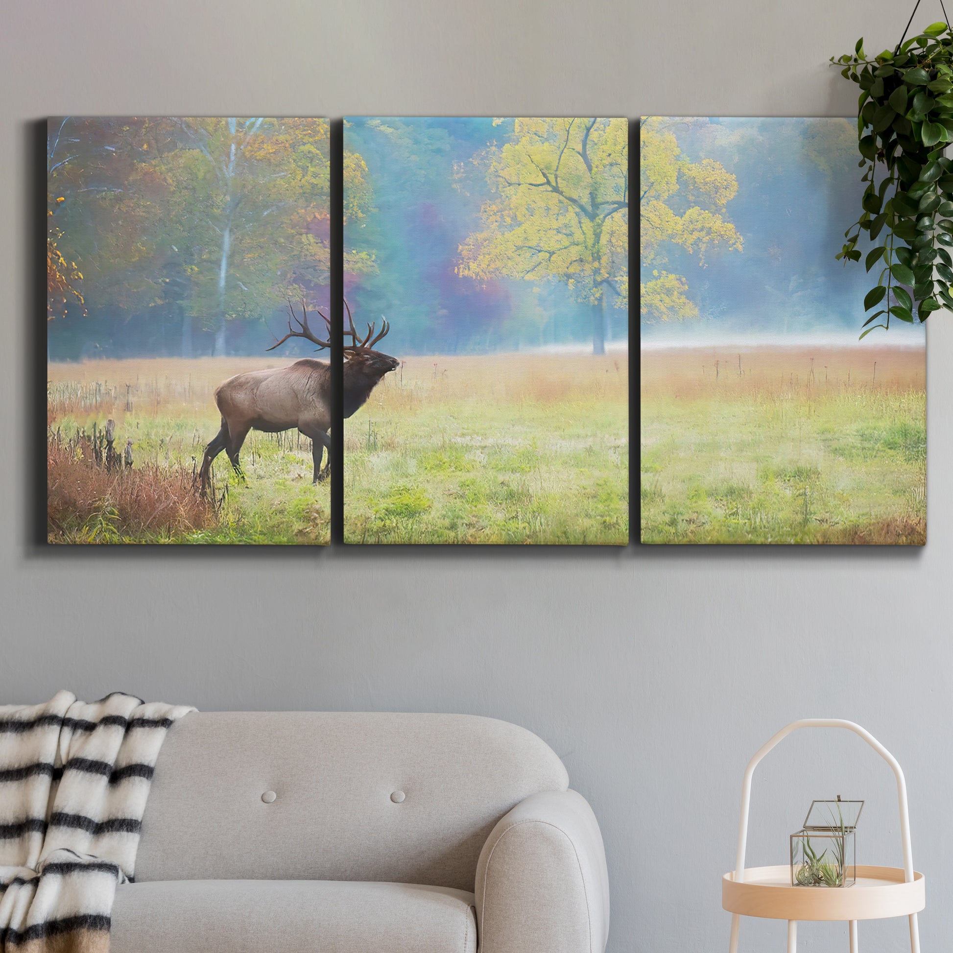 Three-panel canvas wall art featuring resting animals in open field, displayed in a modern living room above a sofa.