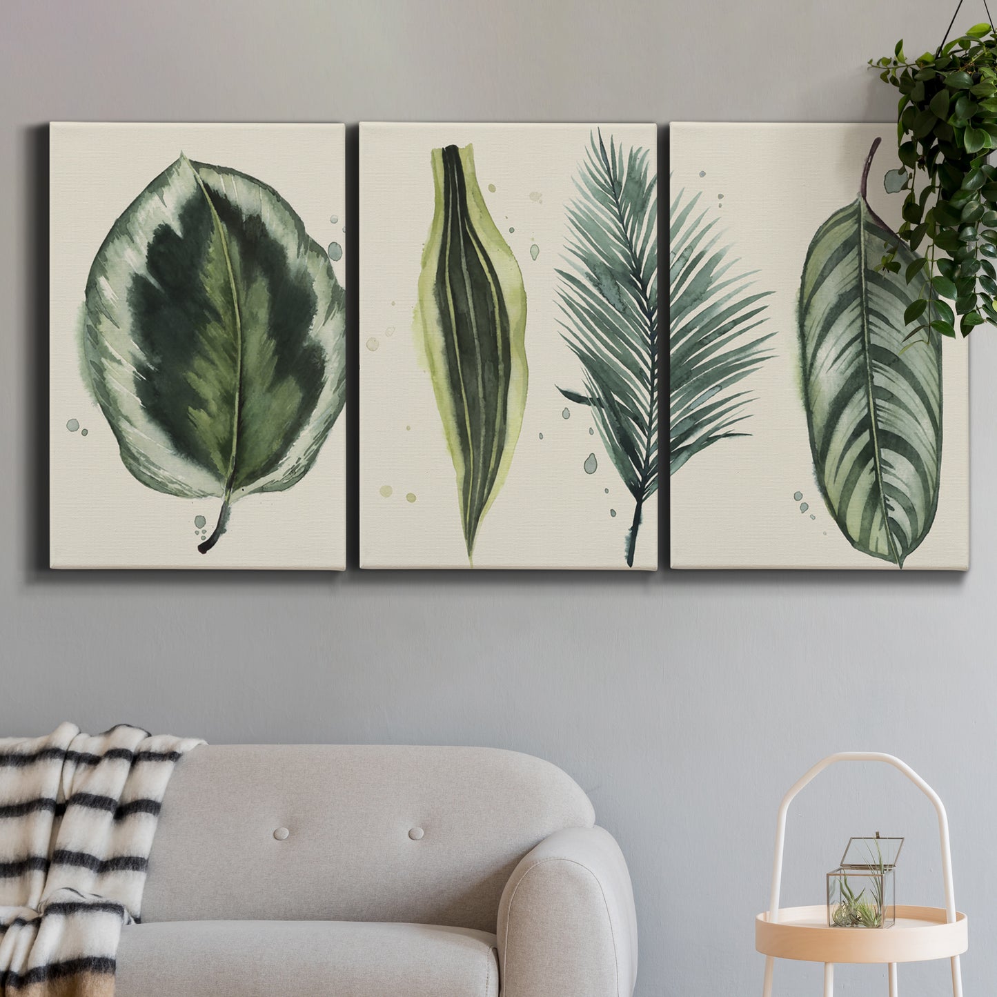 Three-panel canvas wall art featuring botanical palm leaf illustration, displayed in a modern living room above a sofa.