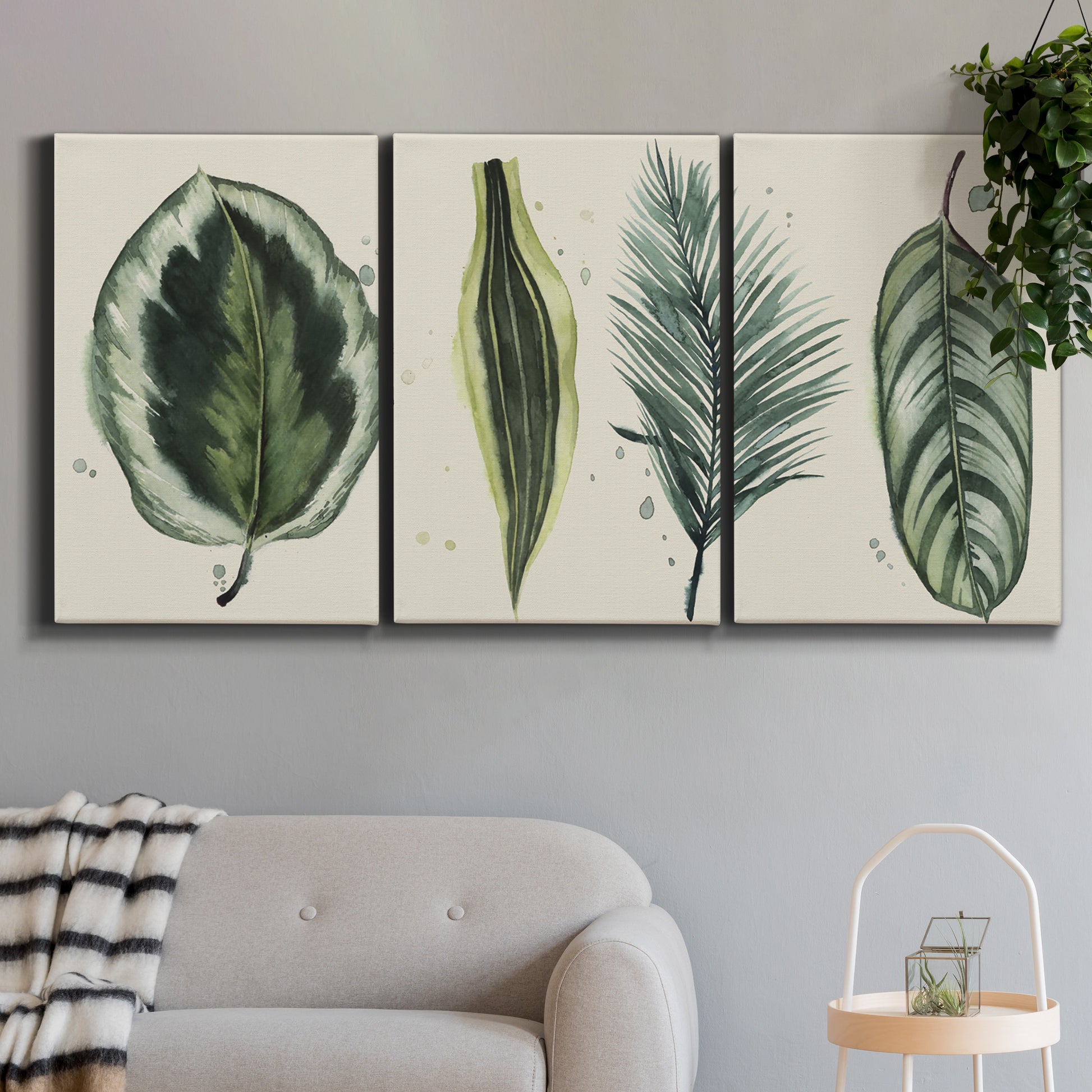 Three-panel canvas wall art featuring botanical palm leaf illustration, displayed in a modern living room above a sofa.