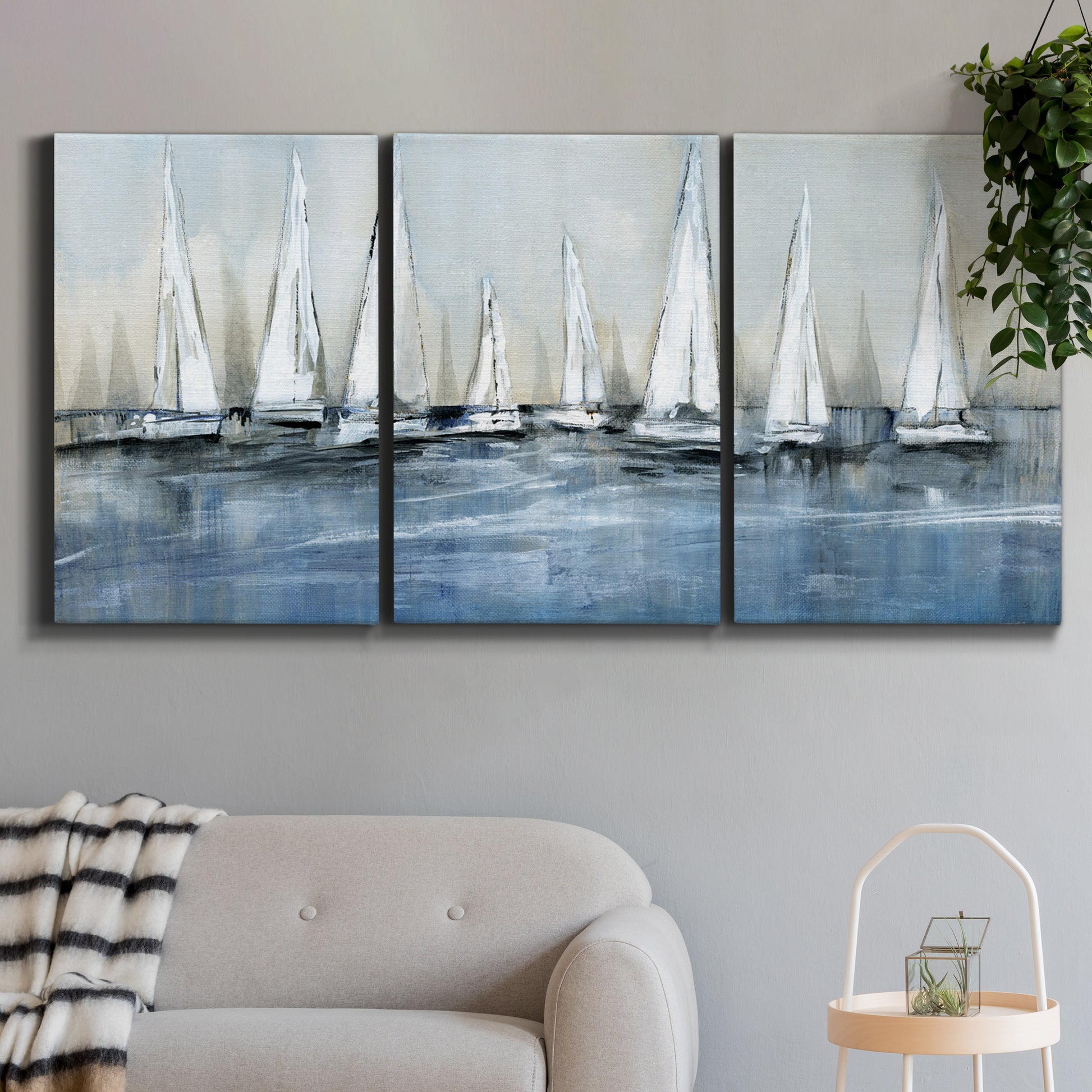 Three-panel canvas wall art featuring still life with pears and grapes, displayed in a modern living room above a sofa.
