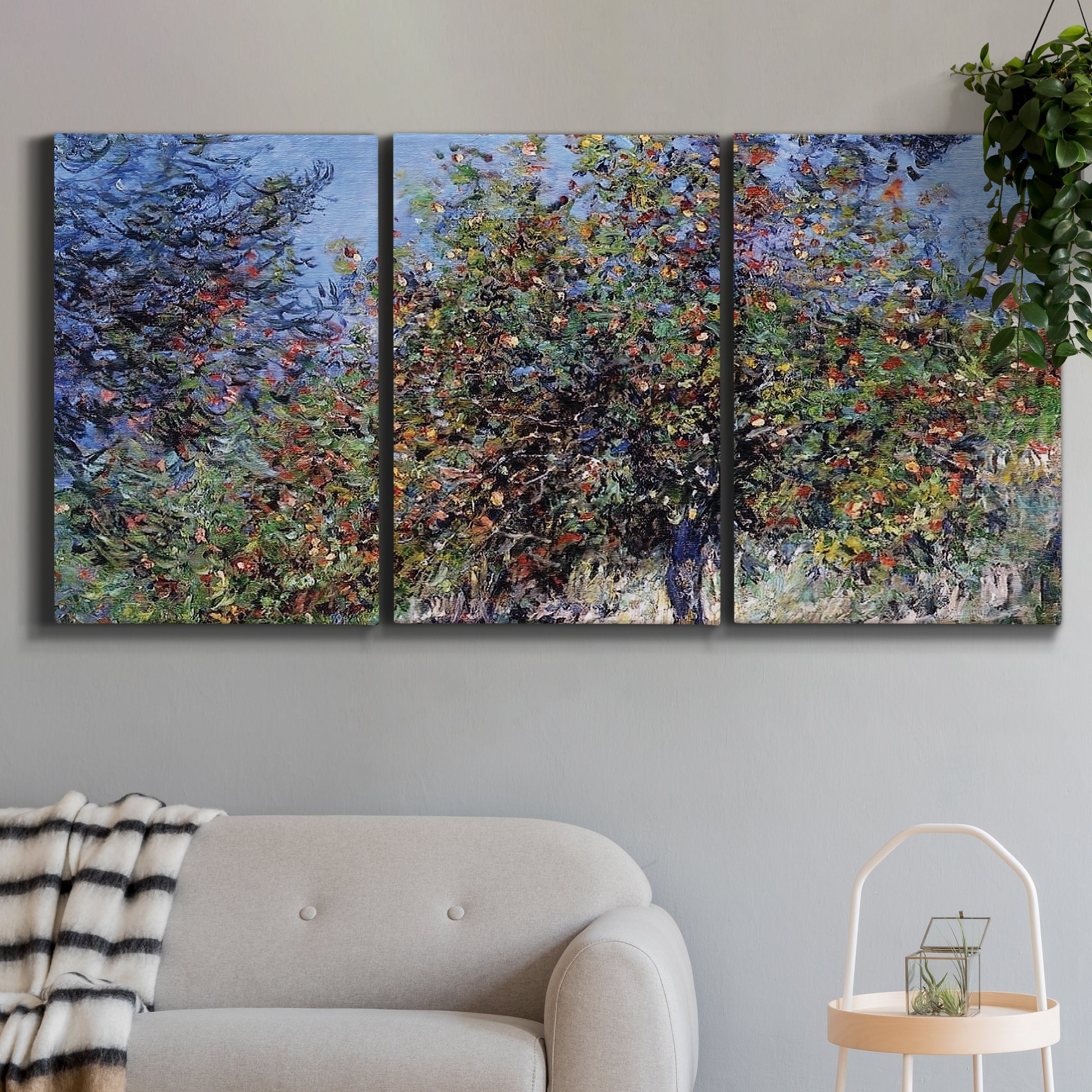 Three-panel canvas wall art featuring orchard of trees in spring bloom, displayed in a modern living room above a sofa.