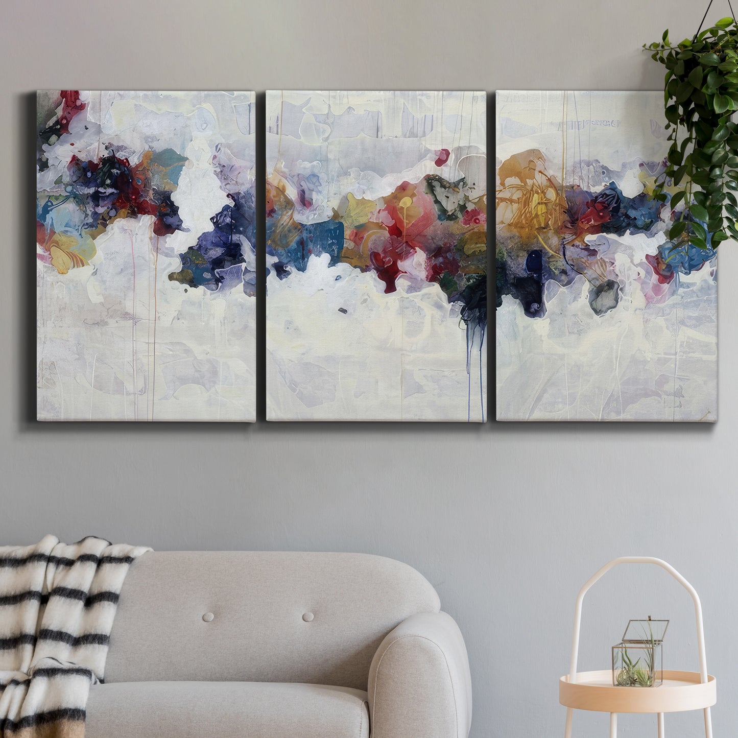 Three-panel canvas wall art featuring abstract water inspired composition, displayed in a modern living room above a sofa.