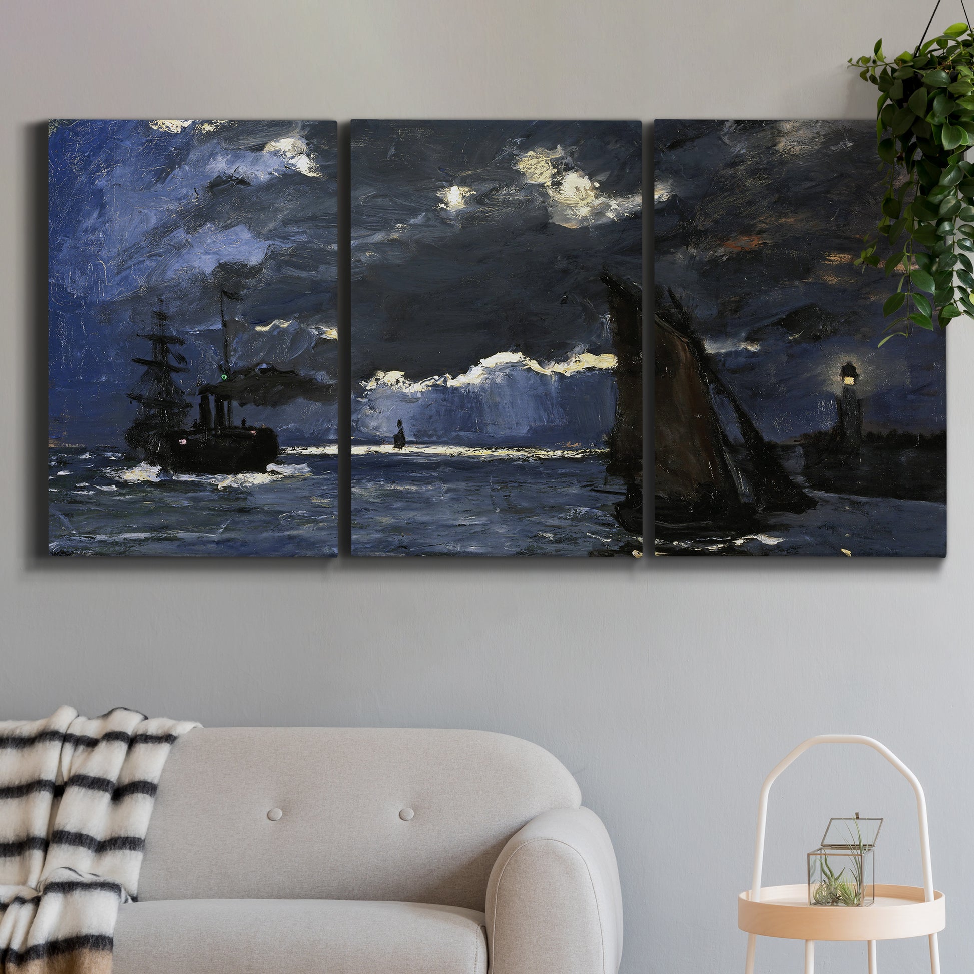 Three-panel canvas wall art featuring dark seascape under night sky, displayed in a modern living room above a sofa.