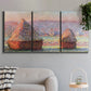 Three-panel canvas wall art featuring winter grainstacks glowing at sunset, displayed in a modern living room above a sofa.