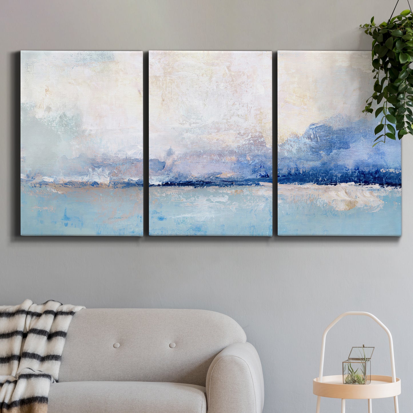 Three-panel canvas wall art featuring abstract bay with rhythmic forms, displayed in a modern living room above a sofa.