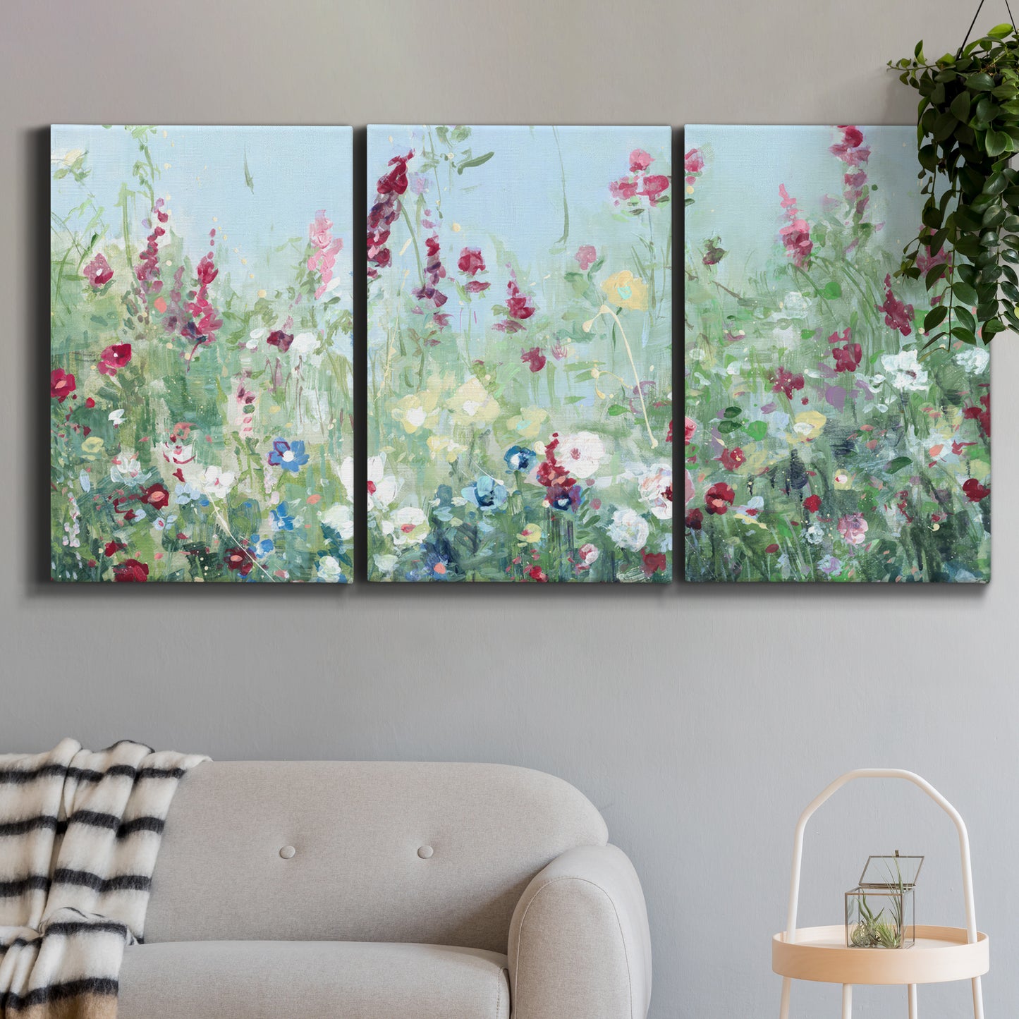 Three-panel canvas wall art featuring night landscape silhouette photography, displayed in a modern living room above a sofa.