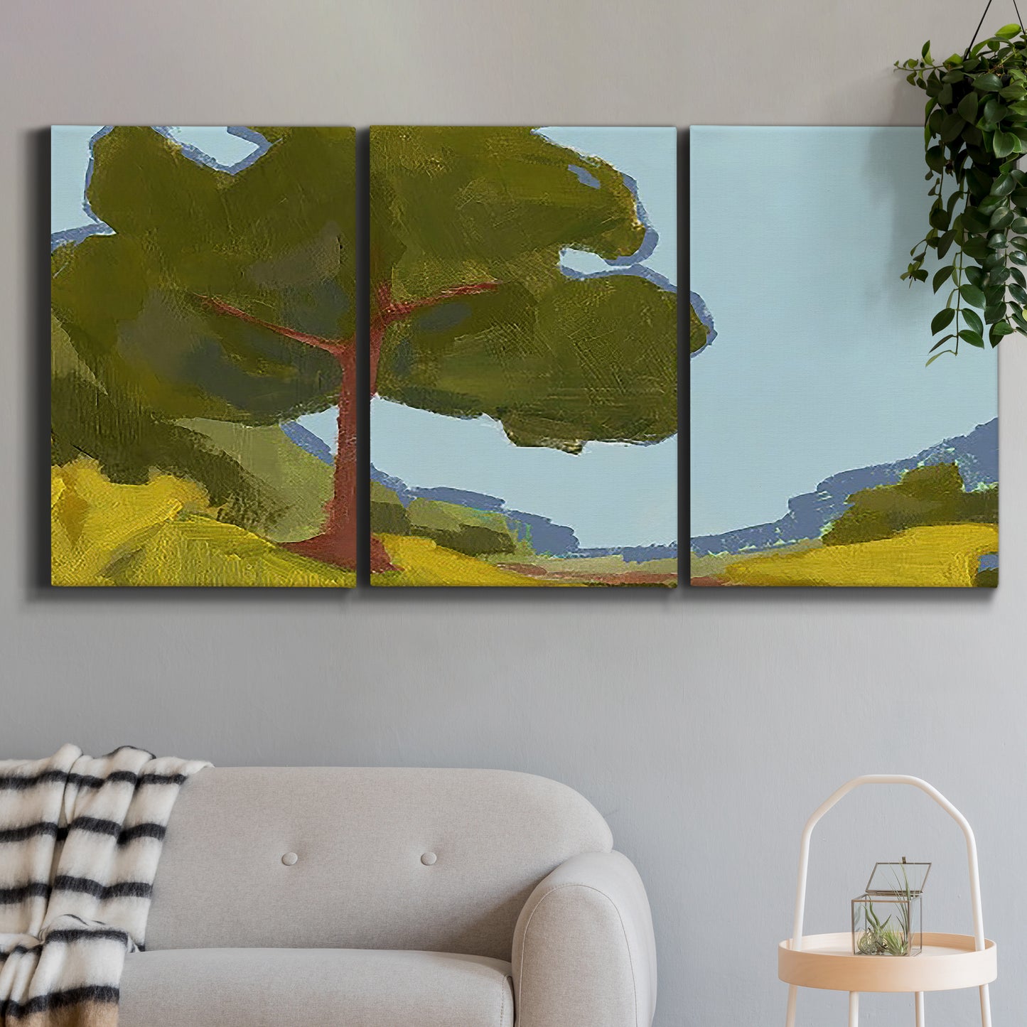Three-panel canvas wall art featuring sunlit public park landscape view, displayed in a modern living room above a sofa.