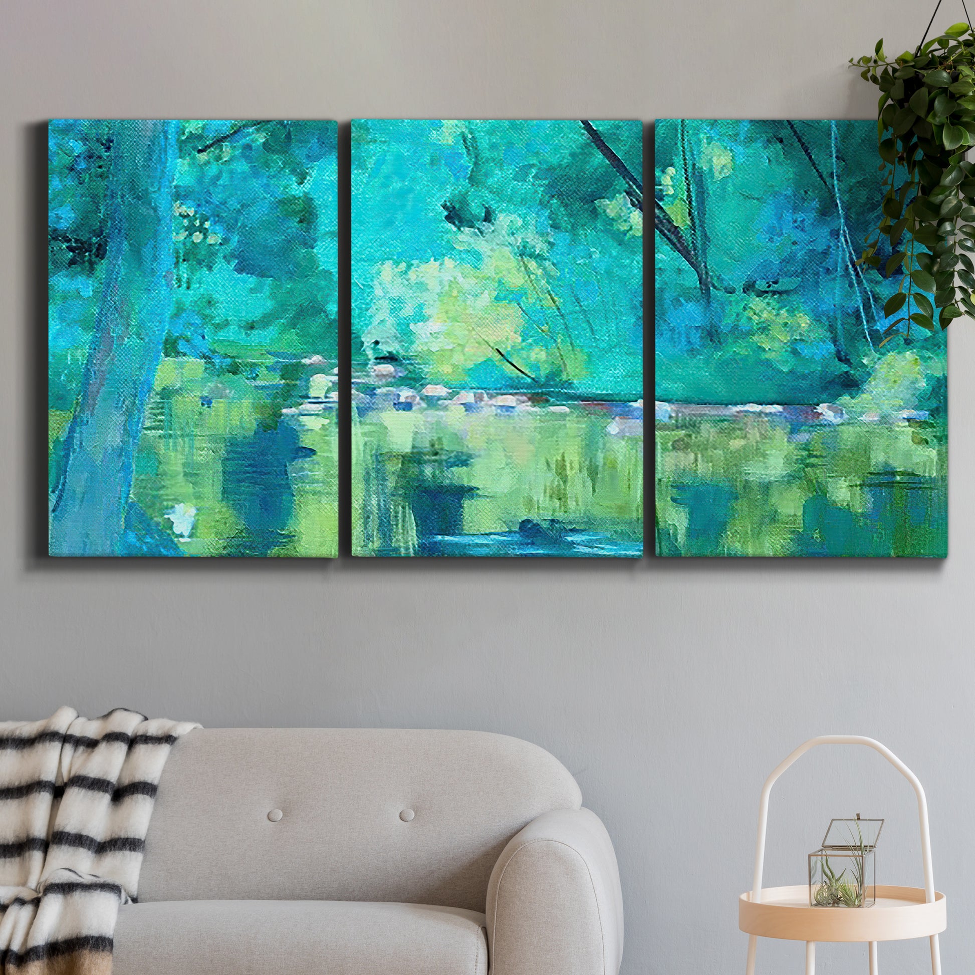 Three-panel canvas wall art featuring abstract river composition with movement, displayed in a modern living room above a sofa.