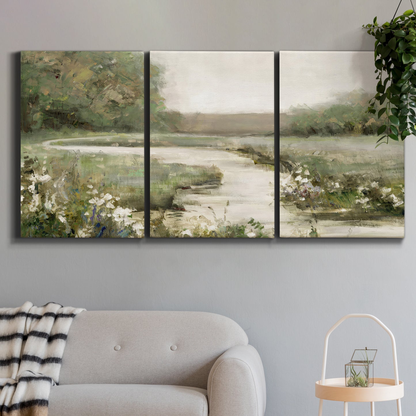 Three-panel canvas wall art featuring narrow path through quiet landscape, displayed in a modern living room above a sofa.