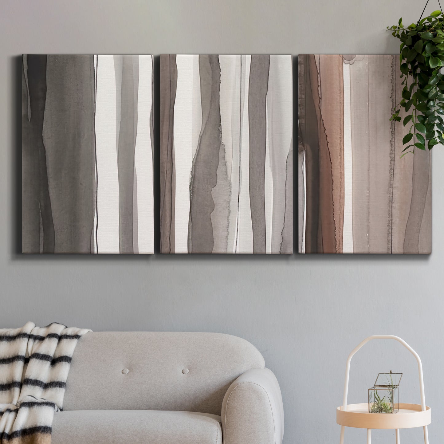 Three-panel canvas wall art featuring riverbank landscape with reflections, displayed in a modern living room above a sofa.
