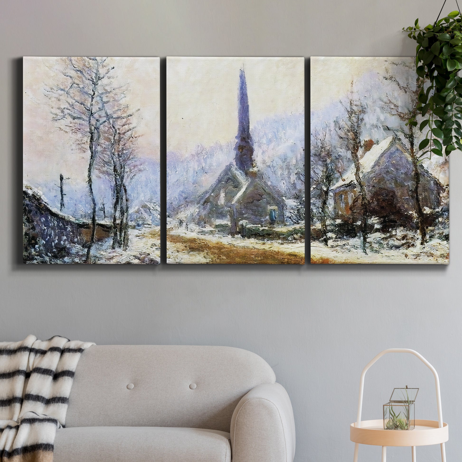 Three-panel canvas wall art featuring snow covered road leading to village, displayed in a modern living room above a sofa.