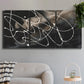 Three-panel canvas wall art featuring dark swirling abstract motion, displayed in a modern living room above a sofa.