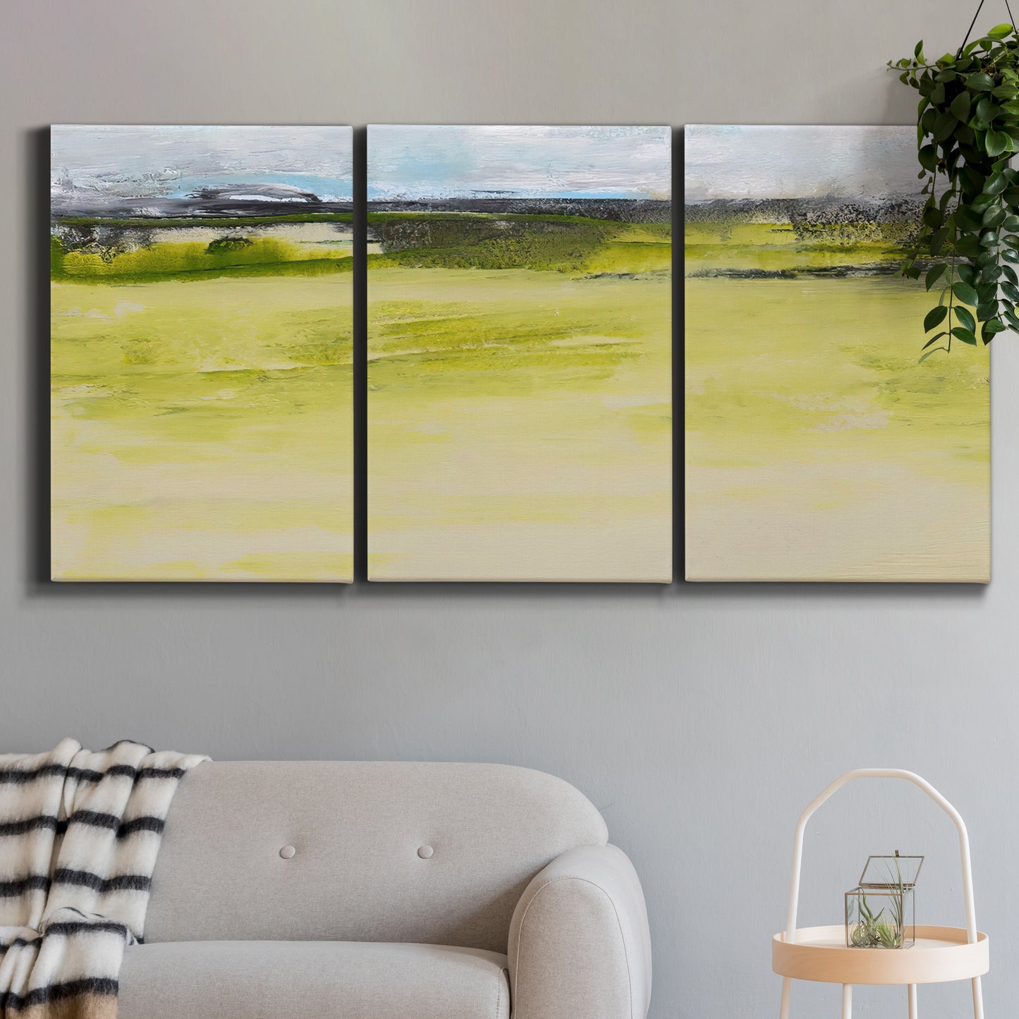 Three-panel canvas wall art featuring abstract terrace landscape view, displayed in a modern living room above a sofa.