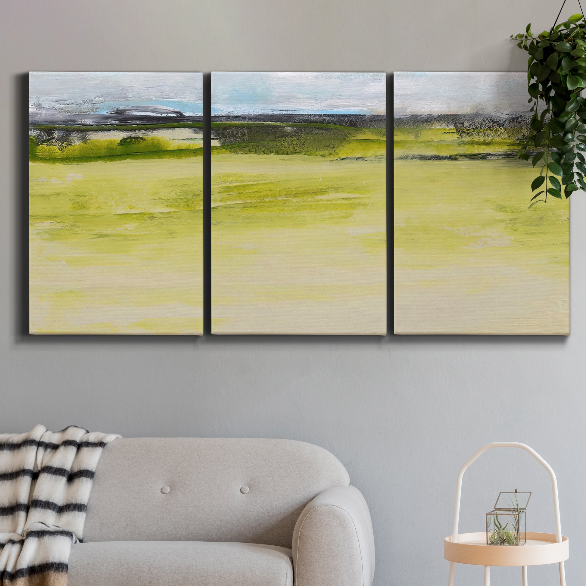 Three-panel canvas wall art featuring abstract terrace landscape view, displayed in a modern living room above a sofa.