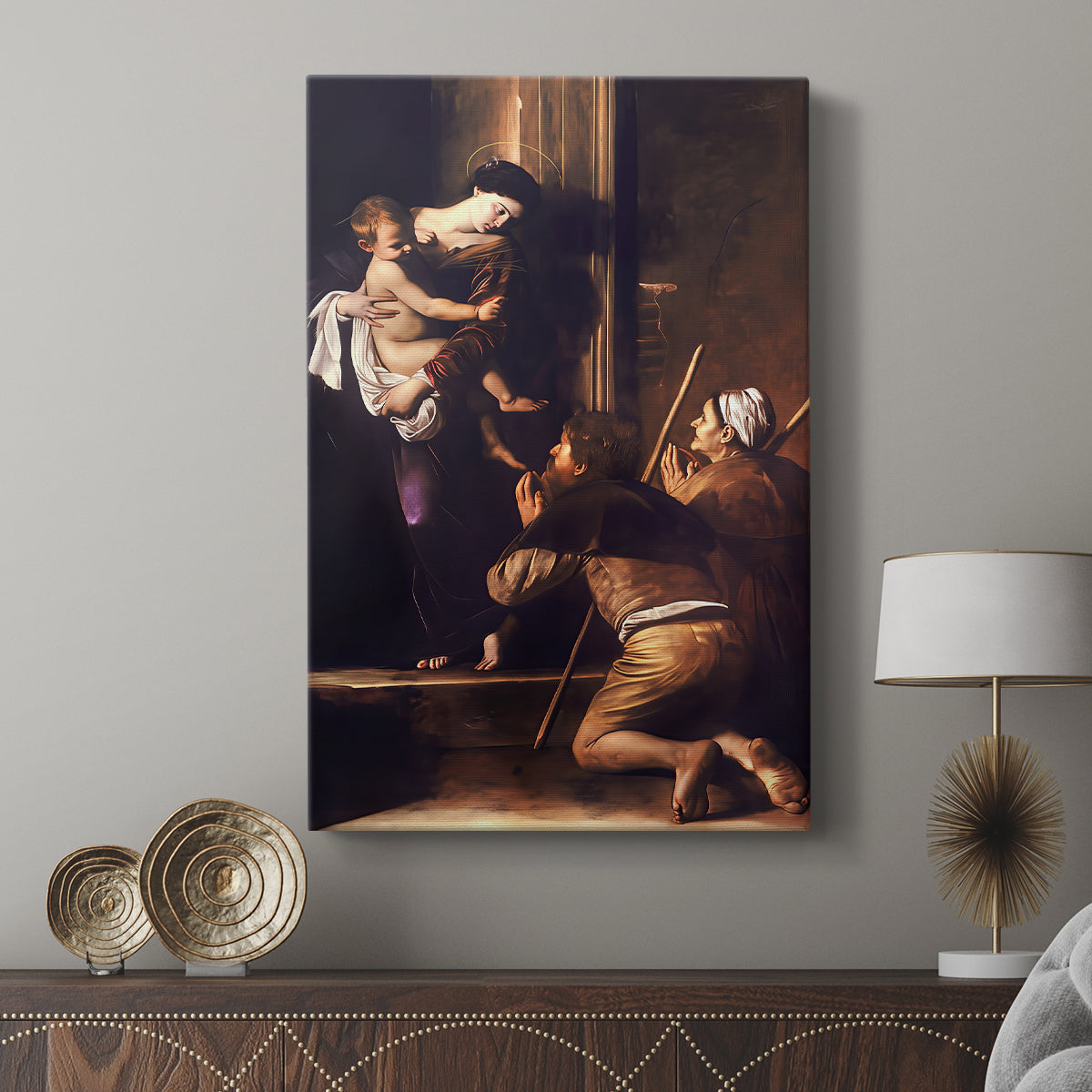 Canvas art print featuring a devotional scene with strong contrast and earthy tones displayed in a modern interior space.