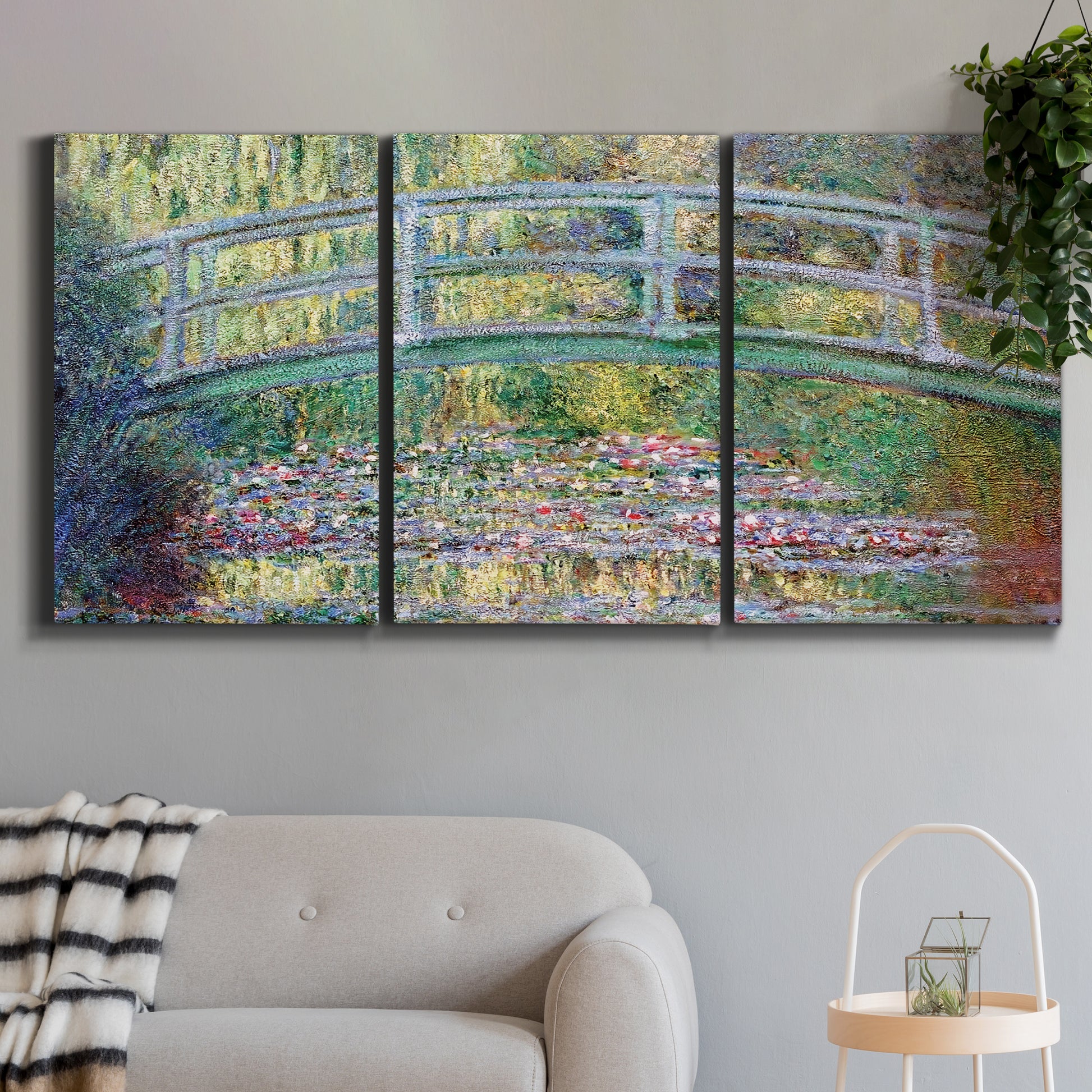 Three-panel canvas wall art featuring water lilies with arched bridge, displayed in a modern living room above a sofa.