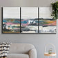 Three-panel canvas wall art featuring cheerful abstract coastal seascape, displayed in a modern living room above a sofa.