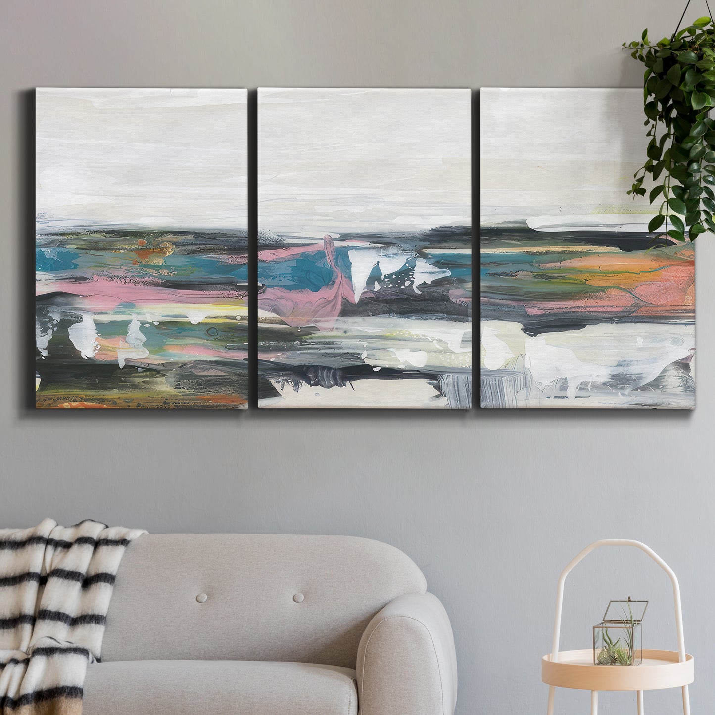 Three-panel canvas wall art featuring cheerful abstract coastal seascape, displayed in a modern living room above a sofa.