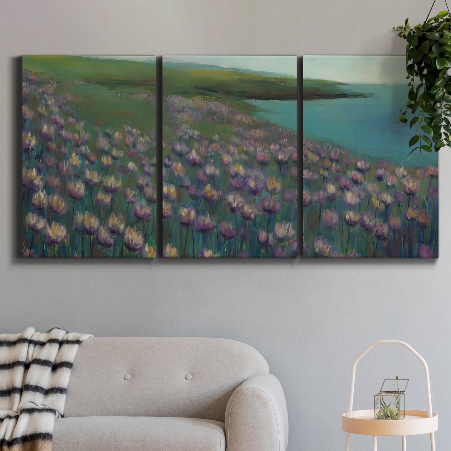 Three-panel canvas wall art featuring calm coastal landscape sanctuary, displayed in a modern living room above a sofa.