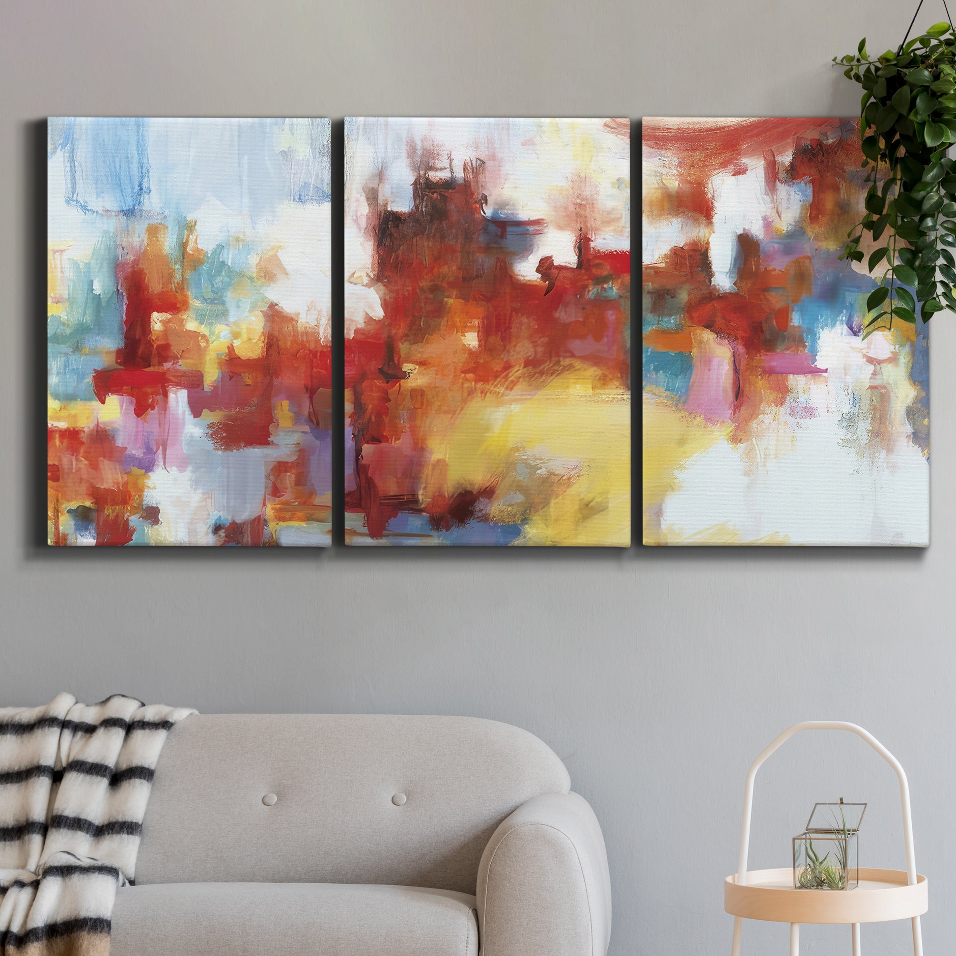 Three-panel canvas wall art featuring abstract city lights composition, displayed in a modern living room above a sofa.