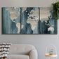 Three-panel canvas wall art featuring golden coastal sunset with cliffs, displayed in a modern living room above a sofa.