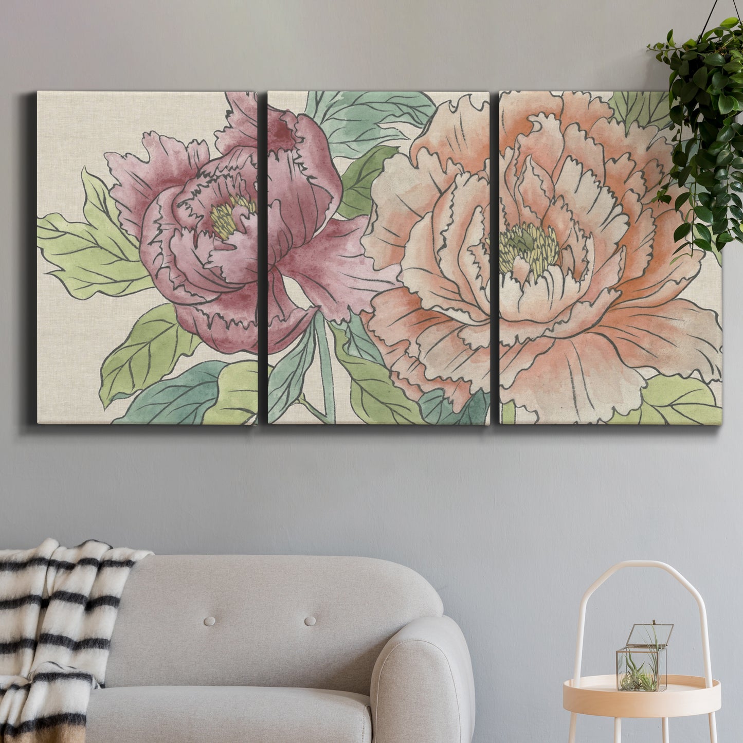 Three-panel canvas wall art featuring pastel peony flower composition, displayed in a modern living room above a sofa.