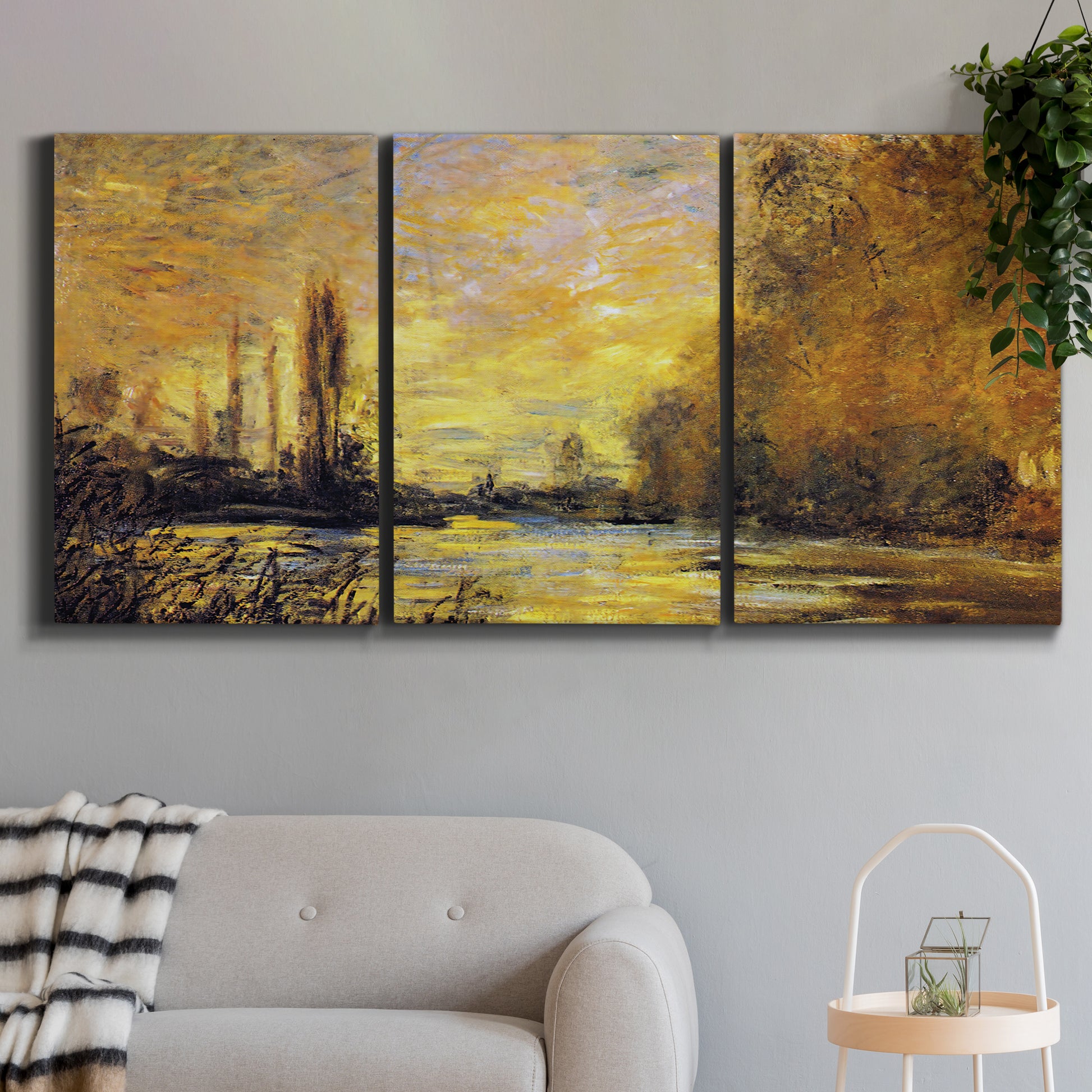 Three-panel canvas wall art featuring quiet river branch landscape, displayed in a modern living room above a sofa.